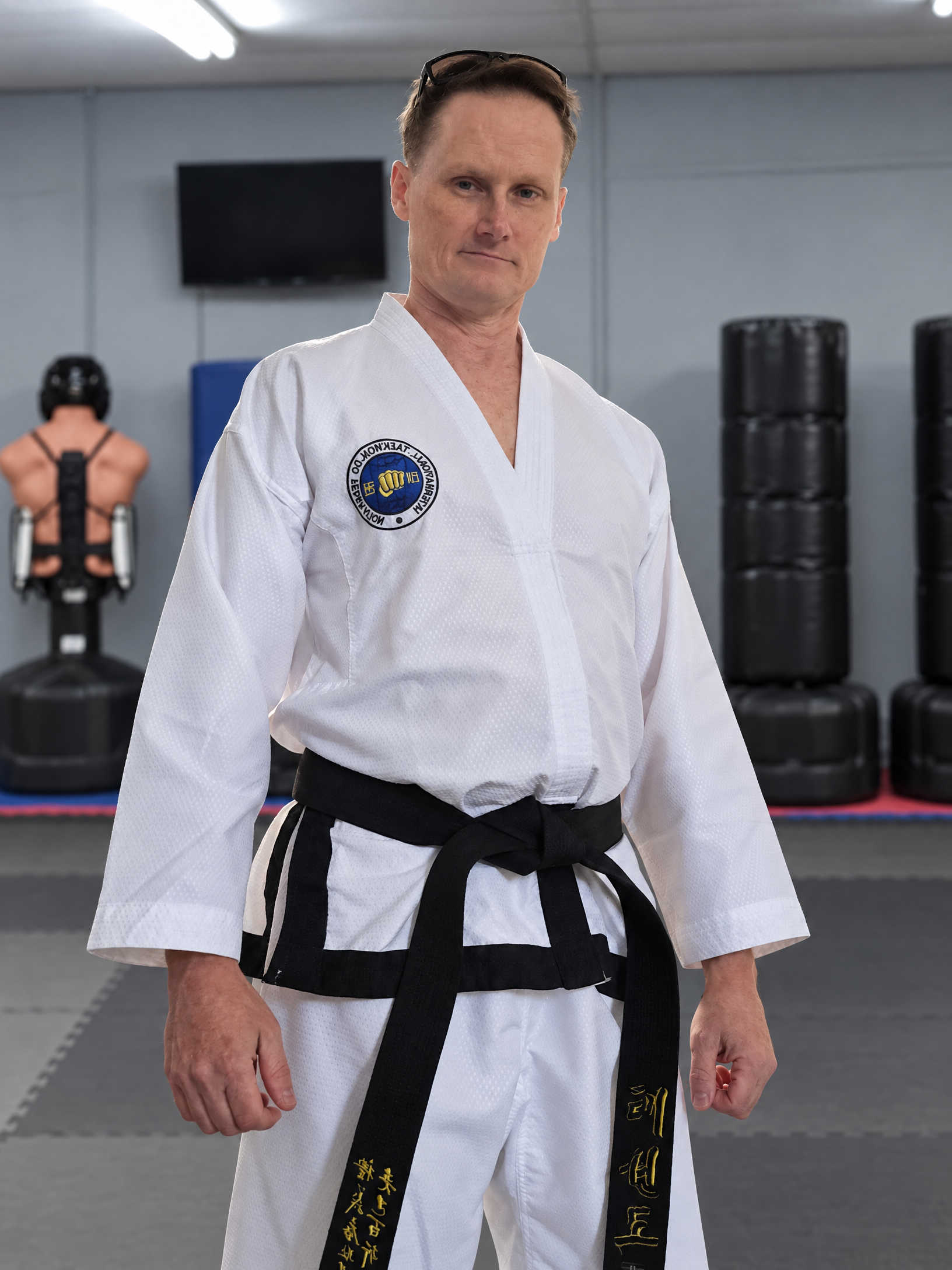 Joseph Dellea in a Taekwondo uniform in a martial arts gym
